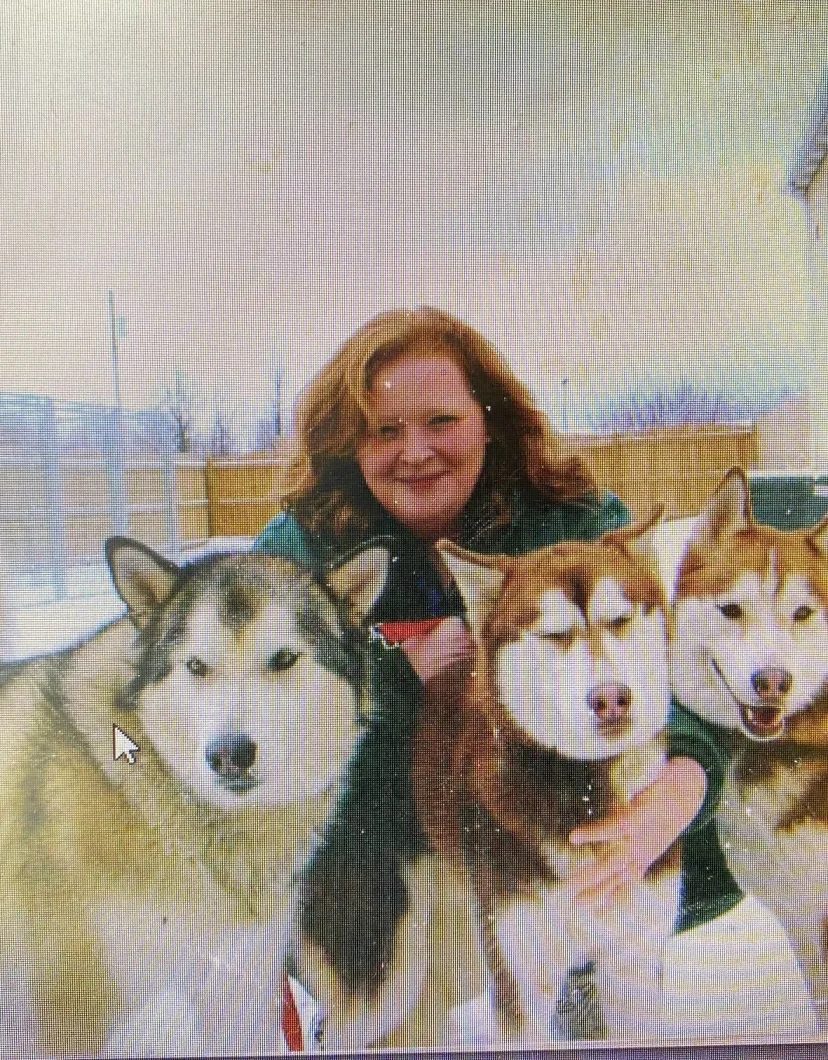 Beth Davis with three huskies.